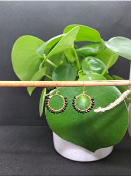 Dormeuses, anneaux et perles à facettes noirs brillantes.